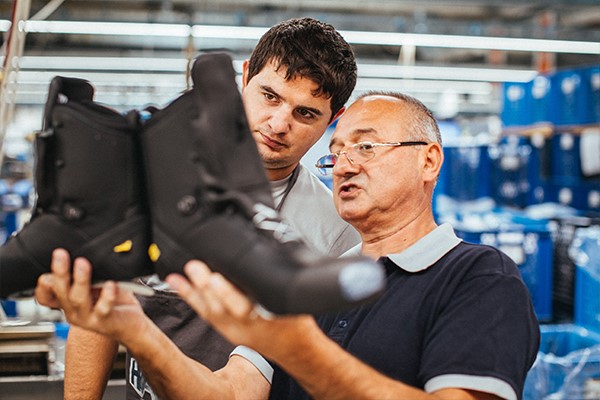 Two HAIX workers assessing a pair of shoes